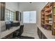Well-lit home office featuring custom built-in shelving and a comfortable workspace at 6801 E Sheena Dr, Scottsdale, AZ 85254