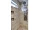 Tile shower featuring a pebble floor, tiled walls, a small window, and a multi-setting shower head at 6801 E Sheena Dr, Scottsdale, AZ 85254