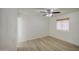 Bright bedroom with light wood flooring and a large window at 7135 E Baywood Ave, Mesa, AZ 85208