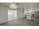 Bright kitchen with white cabinets, stainless appliances, and wood-look tile floors provides ample space at 7135 E Baywood Ave, Mesa, AZ 85208