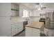 A well-lit kitchen with stainless steel appliances, white cabinets, and tile backsplash awaits a home chef at 7135 E Baywood Ave, Mesa, AZ 85208