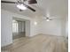 Open living room featuring modern flooring, neutral walls, and two ceiling fans at 7135 E Baywood Ave, Mesa, AZ 85208