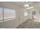 Sunroom featuring neutral paint, many windows and a door, a ceiling fan, and gray wood-look tile flooring at 7135 E Baywood Ave, Mesa, AZ 85208