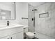 Bathroom featuring tiled shower, modern vanity, and sleek black fixtures at 7230 N 70Th Ln, Glendale, AZ 85303