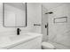 Modern bathroom featuring sleek fixtures, a vanity, a toilet, and a shower with marble-look tile at 7230 N 70Th Ln, Glendale, AZ 85303