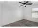 Bright bedroom featuring wood-look floors, and a window with backyard views at 7230 N 70Th Ln, Glendale, AZ 85303