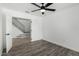 Bedroom showcasing hardwood flooring and access to the staircase at 7230 N 70Th Ln, Glendale, AZ 85303
