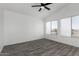Bedroom featuring vaulted ceiling, ceiling fan, two windows, and wood-look floors at 7230 N 70Th Ln, Glendale, AZ 85303
