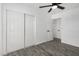Bedroom with hardwood floors and a modern ceiling fan, complemented by ample closet space at 7230 N 70Th Ln, Glendale, AZ 85303