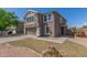 Well-kept home with an attached garage, tidy lawn, and simple desert landscaping at 7230 N 70Th Ln, Glendale, AZ 85303