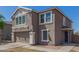Attractive home with a well-kept lawn, a two-car garage, and desert landscaping at 7230 N 70Th Ln, Glendale, AZ 85303
