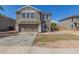 Charming two-story home with a well-maintained front yard and an attached two-car garage at 7230 N 70Th Ln, Glendale, AZ 85303