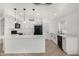 Well-lit kitchen boasts white cabinets, quartz countertops, and black appliances at 7230 N 70Th Ln, Glendale, AZ 85303