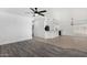 Open-concept living room with vinyl plank flooring that extends into an open kitchen area at 7230 N 70Th Ln, Glendale, AZ 85303