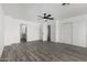 Spacious main bedroom boasts a modern ceiling fan, wood-look floors, and a walk-in closet for ample storage at 7230 N 70Th Ln, Glendale, AZ 85303