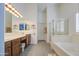 Bright bathroom featuring a double vanity, separate shower, and large soaking tub at 737 W Desert Valley Dr, San Tan Valley, AZ 85143
