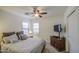 Bedroom with a ceiling fan, large windows, and a TV, creating a comfortable and relaxing space at 737 W Desert Valley Dr, San Tan Valley, AZ 85143