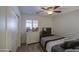 Cozy bedroom with a modern dresser, ceiling fan, and plush carpet at 737 W Desert Valley Dr, San Tan Valley, AZ 85143