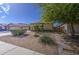 Charming single-story home with a well-manicured front yard, desert landscaping, and a three car garage at 737 W Desert Valley Dr, San Tan Valley, AZ 85143