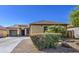 Charming single-story home with a well-maintained front yard, desert landscaping and a two car garage at 737 W Desert Valley Dr, San Tan Valley, AZ 85143