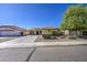 Charming single-story home with a well-manicured front yard, desert landscaping, and a three car garage at 737 W Desert Valley Dr, San Tan Valley, AZ 85143