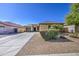 Charming single-story home with a well-manicured front yard, desert landscaping, and a three car garage at 737 W Desert Valley Dr, San Tan Valley, AZ 85143