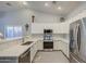 Modern kitchen featuring white cabinetry, stainless steel appliances, and sleek countertops at 737 W Desert Valley Dr, San Tan Valley, AZ 85143