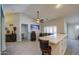 Open-concept living space featuring tile flooring, ceiling fan and bar seating at the countertop at 737 W Desert Valley Dr, San Tan Valley, AZ 85143