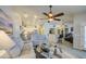 Spacious living room with stylish furnishings, a ceiling fan, and an open layout into the kitchen at 737 W Desert Valley Dr, San Tan Valley, AZ 85143
