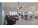 Inviting living room with a ceiling fan, comfortable leather seating, and tiled floors throughout at 737 W Desert Valley Dr, San Tan Valley, AZ 85143