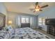 Bright main bedroom featuring a large window, ceiling fan, and TV at 737 W Desert Valley Dr, San Tan Valley, AZ 85143