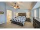 Comfortable primary bedroom with tiled floors, ceiling fan, and ensuite bathroom at 737 W Desert Valley Dr, San Tan Valley, AZ 85143