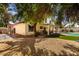 Spacious backyard with a lush green lawn, a sparkling pool, and a covered patio ideal for entertaining guests at 7402 W Kerry Way, Glendale, AZ 85308