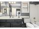 Well-lit bathroom with a vanity, toilet, shower-tub combination, and shuttered window at 7402 W Kerry Way, Glendale, AZ 85308