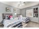 Charming bedroom with two twin beds, matching nightstand, and shuttered window at 7402 W Kerry Way, Glendale, AZ 85308