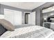 Cozy bedroom showcasing a queen-size bed, full-length mirror, and double-door closet at 7402 W Kerry Way, Glendale, AZ 85308