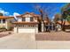 Charming two-story home featuring a tile roof, two-car garage, and desert landscaping at 7402 W Kerry Way, Glendale, AZ 85308
