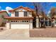 Charming two-story home featuring a tile roof, two-car garage, and desert landscaping at 7402 W Kerry Way, Glendale, AZ 85308