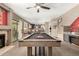 Billiard table, access to the kitchen, stairs, and outdoor living space creates a desirable game room at 7402 W Kerry Way, Glendale, AZ 85308