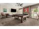 Bright game room with a pool table, media center, bench seating and access to outdoor pool at 7402 W Kerry Way, Glendale, AZ 85308