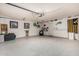Spacious garage with epoxy flooring, wall decorations, and ample storage space at 7402 W Kerry Way, Glendale, AZ 85308