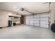Well-organized garage with epoxy flooring, storage cabinets, and an automatic garage door at 7402 W Kerry Way, Glendale, AZ 85308