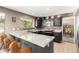 An inviting kitchen features dark cabinetry, granite countertops, and stainless steel appliances at 7402 W Kerry Way, Glendale, AZ 85308