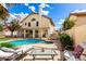 Inviting backyard with a refreshing pool, spa, lounge chairs, and a well-manicured lawn, creating a perfect retreat at 7402 W Kerry Way, Glendale, AZ 85308