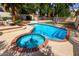Backyard swimming pool and spa featuring a brick border and deck; surrounded by mature landscaping for privacy at 7402 W Kerry Way, Glendale, AZ 85308