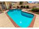 Inviting pool and patio featuring a sparkling blue pool, well-maintained deck, and lush landscaping for backyard bliss at 7402 W Kerry Way, Glendale, AZ 85308