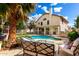 Serene backyard featuring a sparkling pool, comfortable patio furniture, and lush landscaping for ultimate relaxation at 7402 W Kerry Way, Glendale, AZ 85308