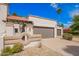 Charming home with a two-car garage, desert landscaping, and a unique architectural design at 7467 E Pleasant Run, Scottsdale, AZ 85258