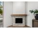 Close up of the modern fireplace with stone surround and decorative mantel, adding warmth to the room at 7467 E Pleasant Run, Scottsdale, AZ 85258