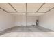 Spacious garage featuring concrete floor, utility hookups, and a pair of doors at 7467 E Pleasant Run, Scottsdale, AZ 85258